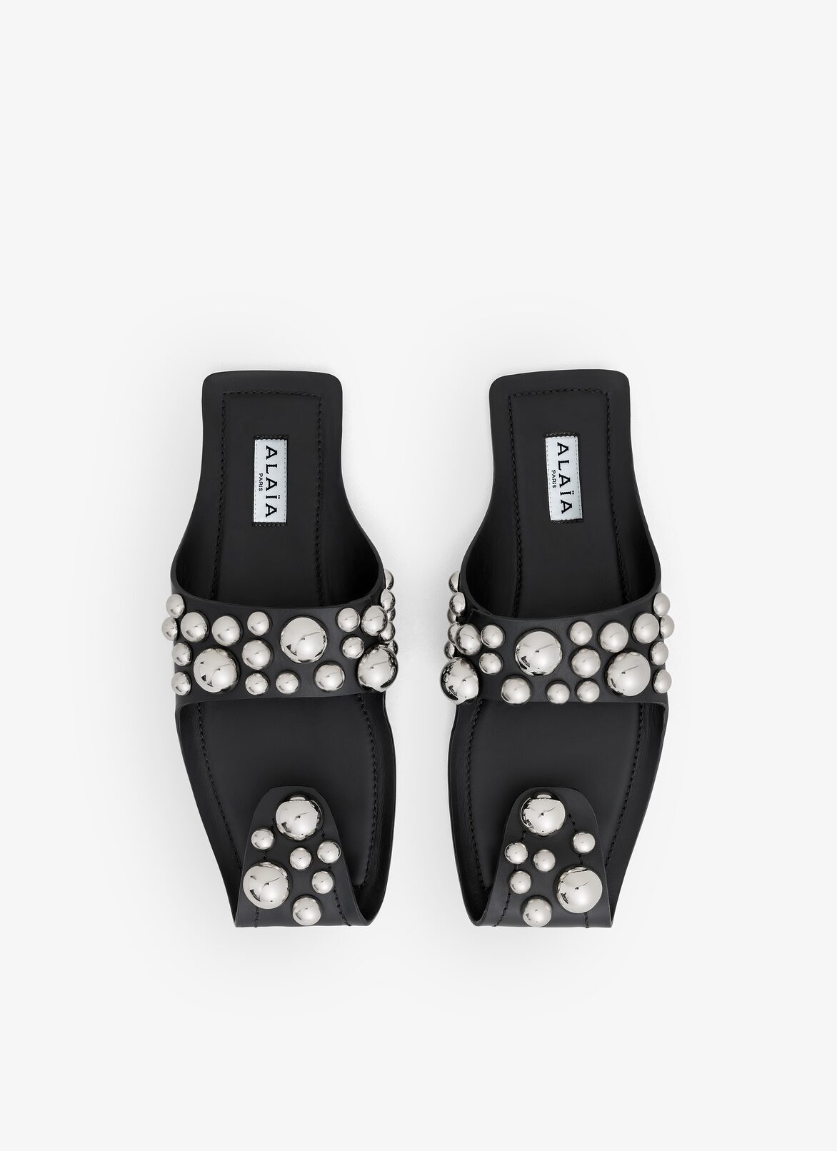 FOLDED FLAT MULES WITH SPHERES ON CALFSKIN ALAÏA BLACK FOLDED FLAT MULES WITH SPHERES ON CALFSKIN